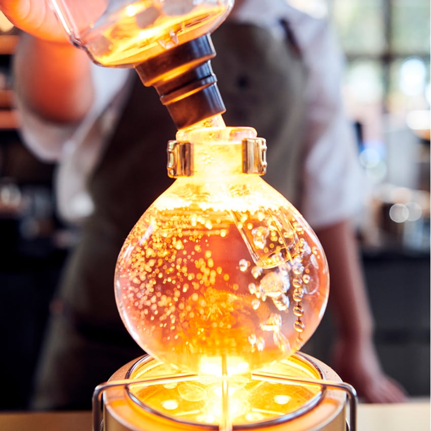 Closeup of liquid bubbling in siphon brewer