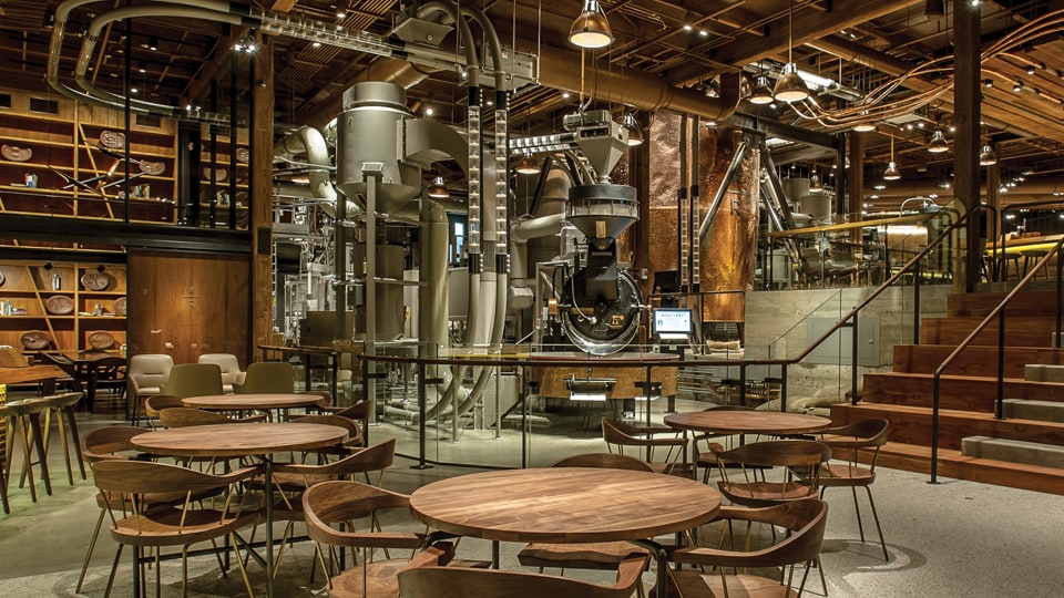 Interior of Seattle Roastery with coffee roasting machinery and chairs and tables