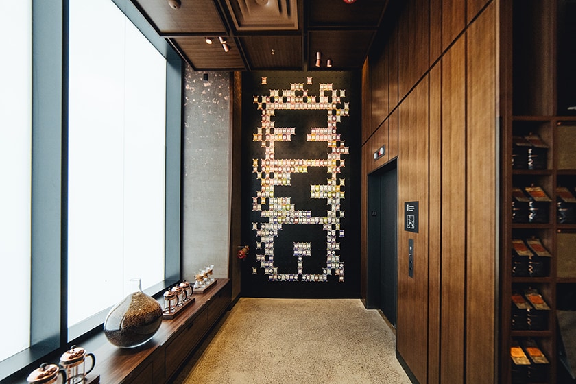 Display of dozens of colorful Starbucks Reserve Coffee Cards on a black wall