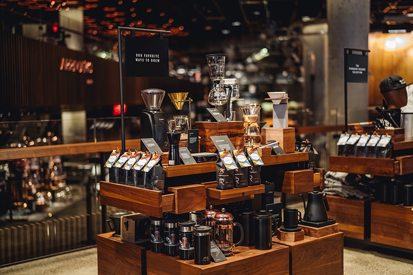 Display table with Starbucks Reserve coffee and a variety of coffee brewing equipment