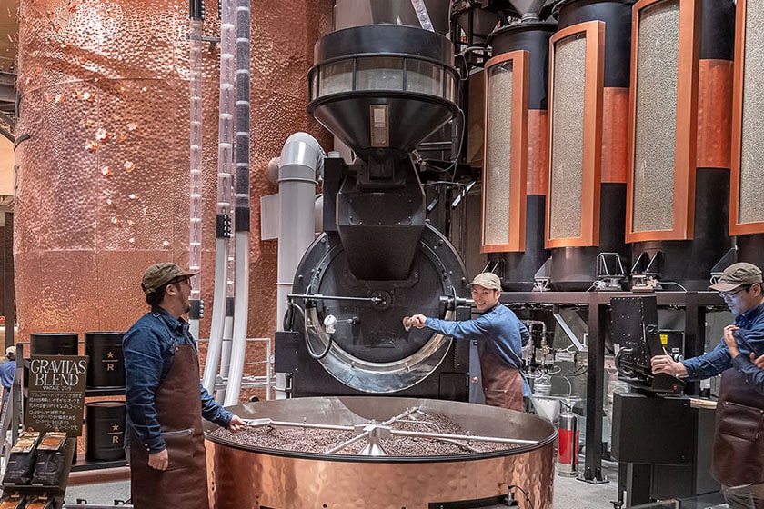 Master Roasters roasting coffee with the large roaster on the ground floor of the Tokyo Roastery