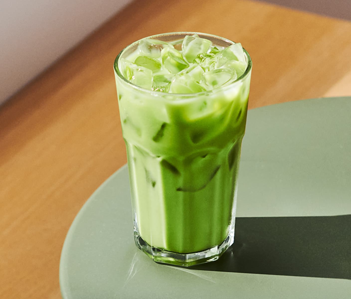 A creamy iced drink in a tall glass on a table.