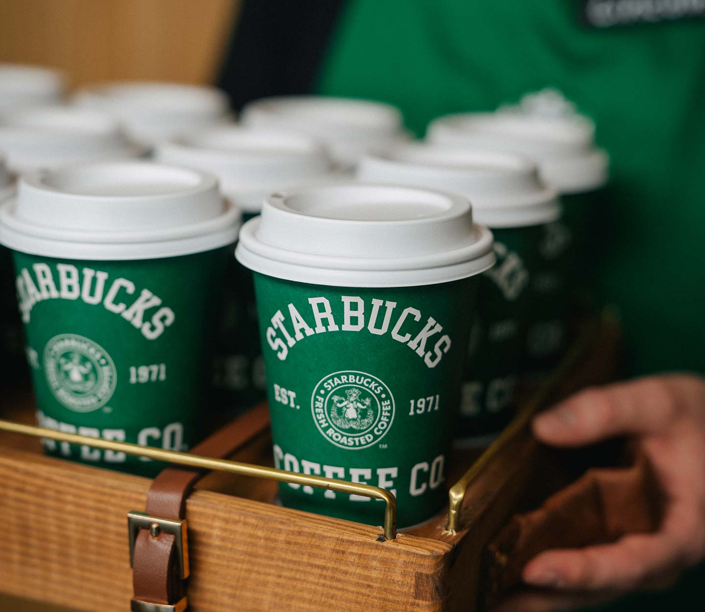 A drink carrier full of special‑edition green cups, inspired by the new Starbucks 1971 roast