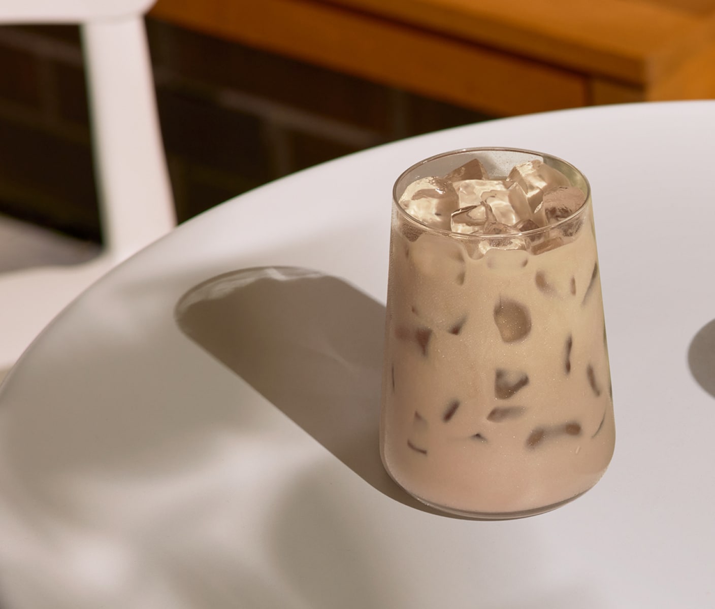 A creamy iced tea drink in a glass.