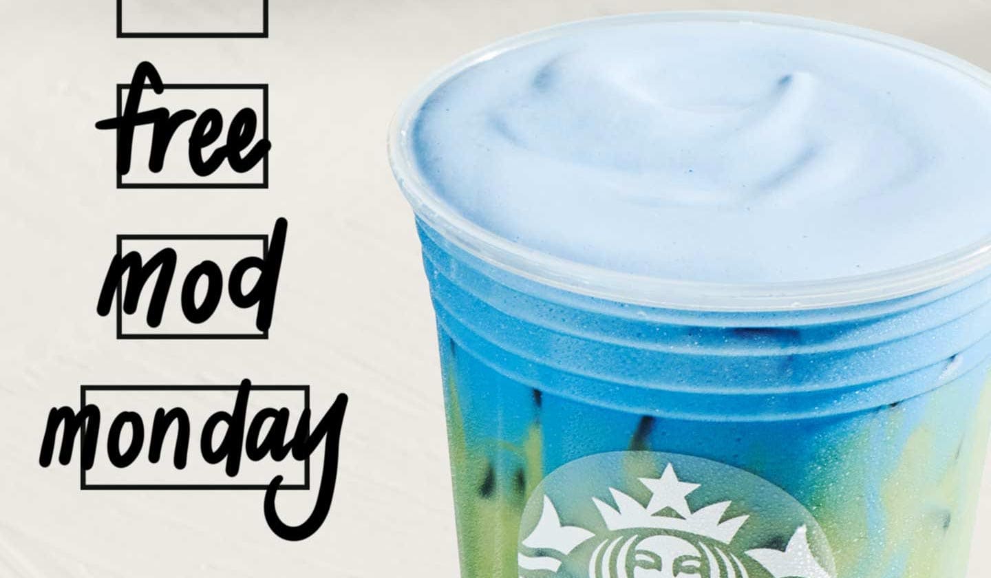 Close-up of a bright iced blue drink. To the left of the drink, three customization box icons have “Free,” “Mod” and “Monday” handwritten inside them in Sharpie.