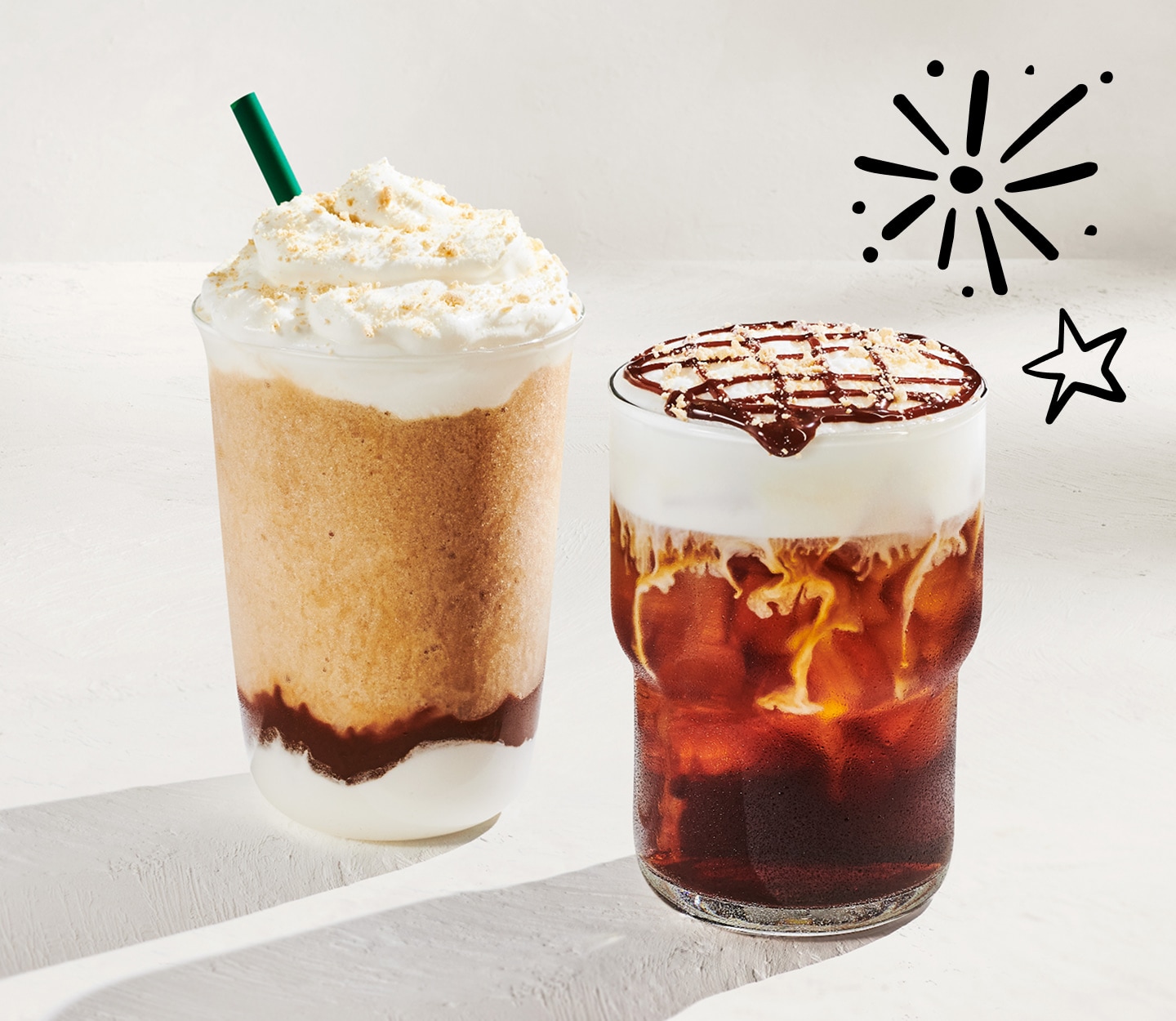 Specialty blended and iced coffee drinks adorned with a firework and star doodle against a light gray background.