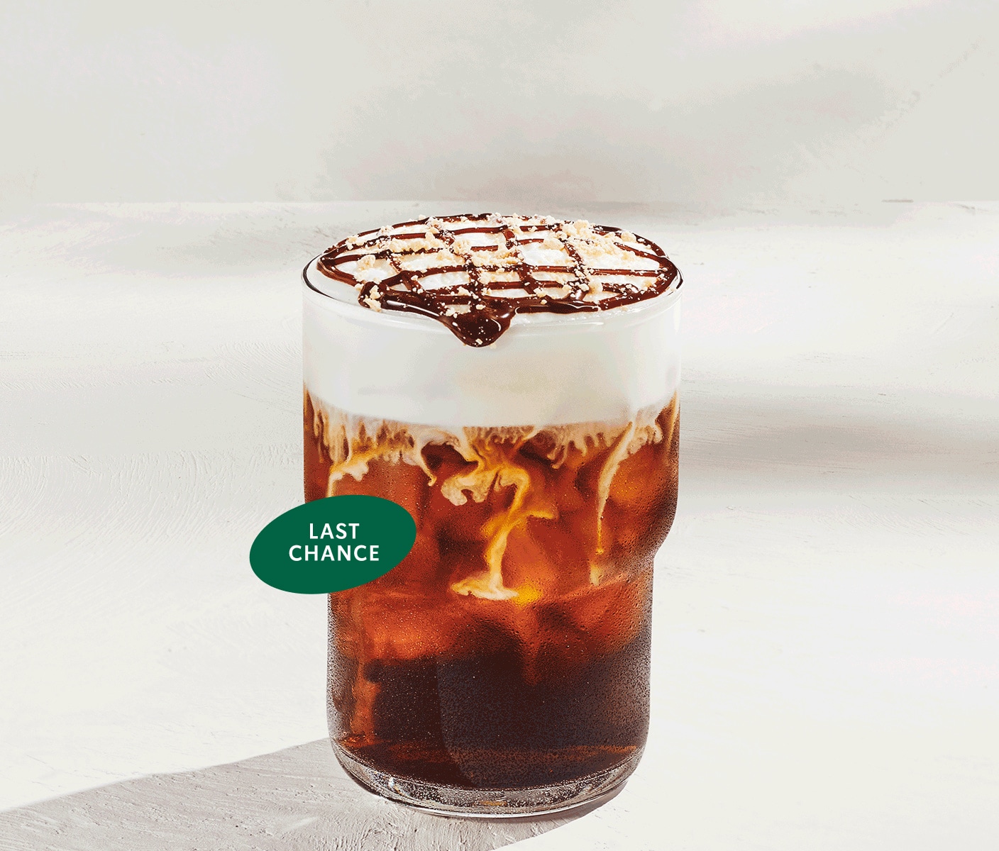 “Last chance” icon overlaps an iced coffee drink with white cold foam, chocolate drizzle and graham-cracker topping