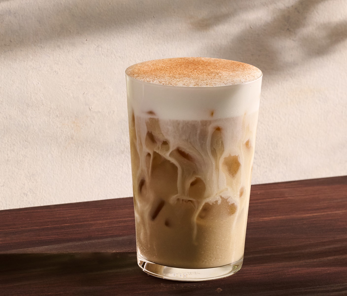 An iced chai with brown sugar cream cold foam and spices.