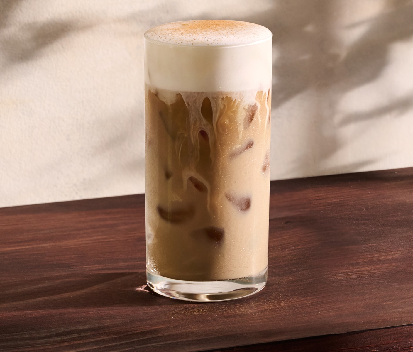 A milky iced coffee drink with brown sugar cream cold foam and spices.