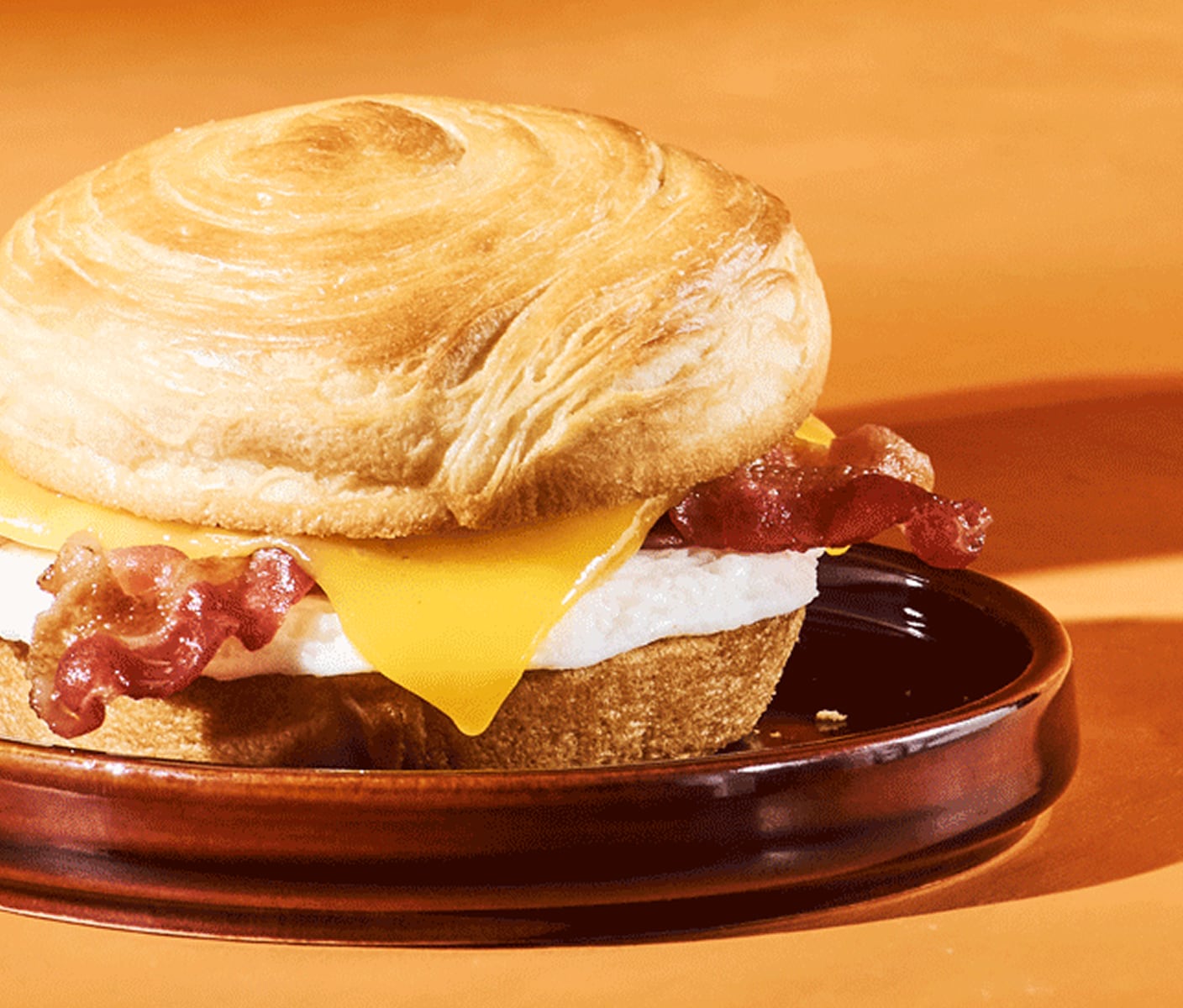 A croissant sandwich with egg, bacon and cheese.