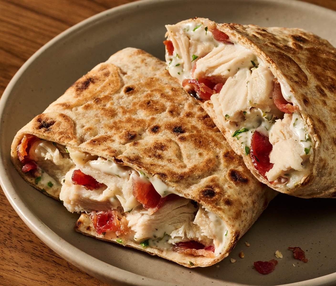A toasted wrap filled with chicken, bacon and herbs.