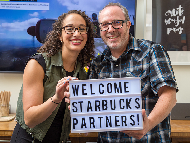 Starbucks partners holding welcome sign