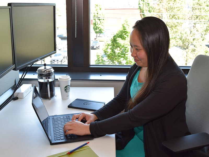 Starbucks intern typing on laptop