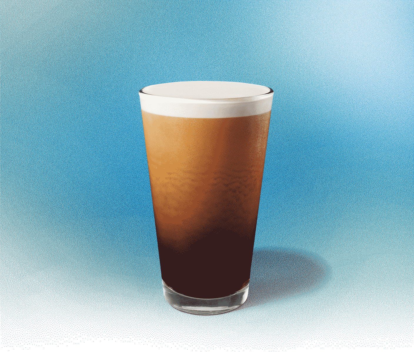 Tall glass of cold coffee with crema at the top
