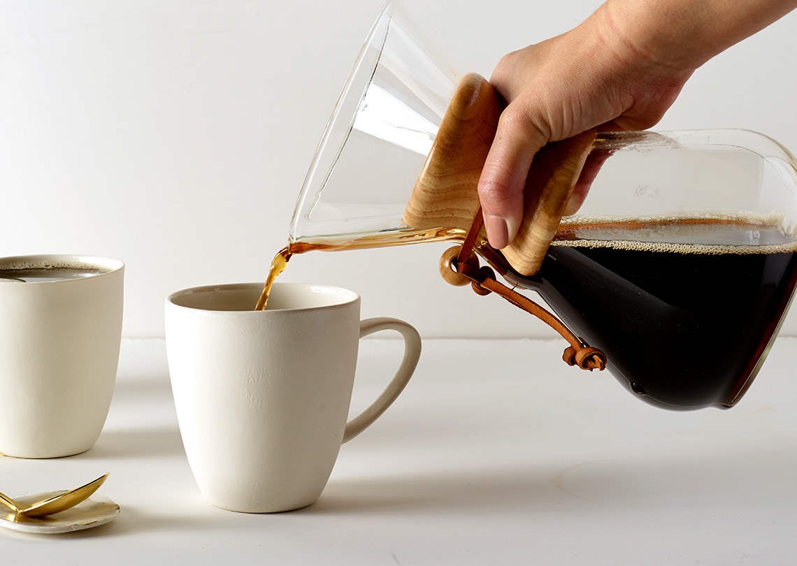 Flash brewed coffee being poured in a mug.
