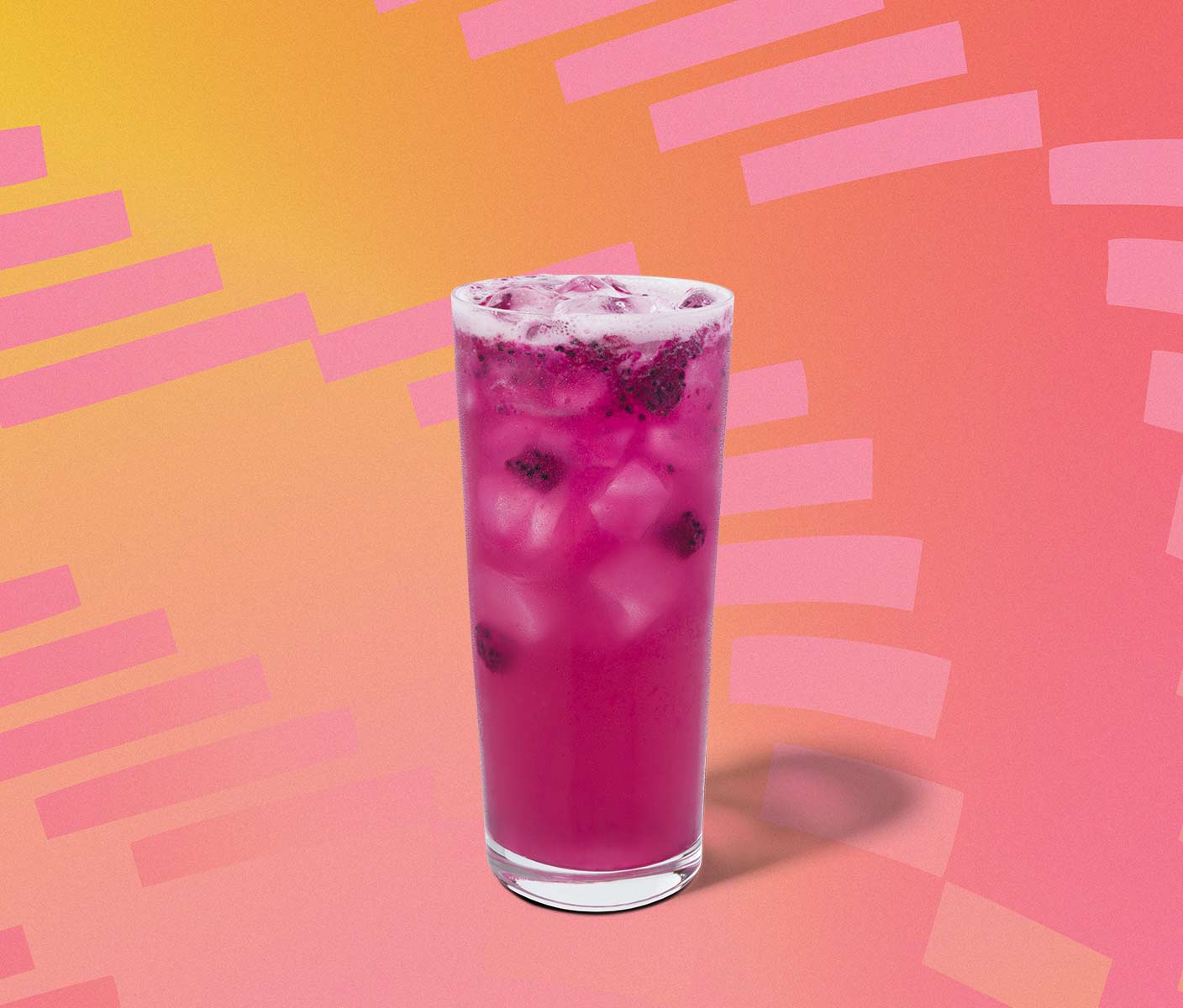 Magenta iced drink with dragonfruit inclusions in a tall glass.