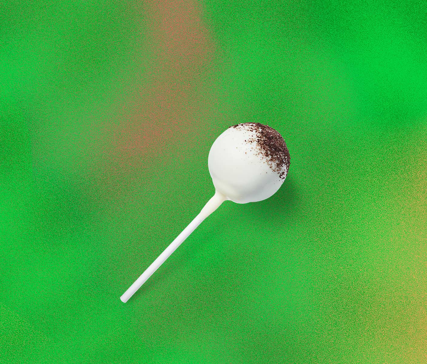 Cake pop with white icing sprinkled with cookie crumbs.