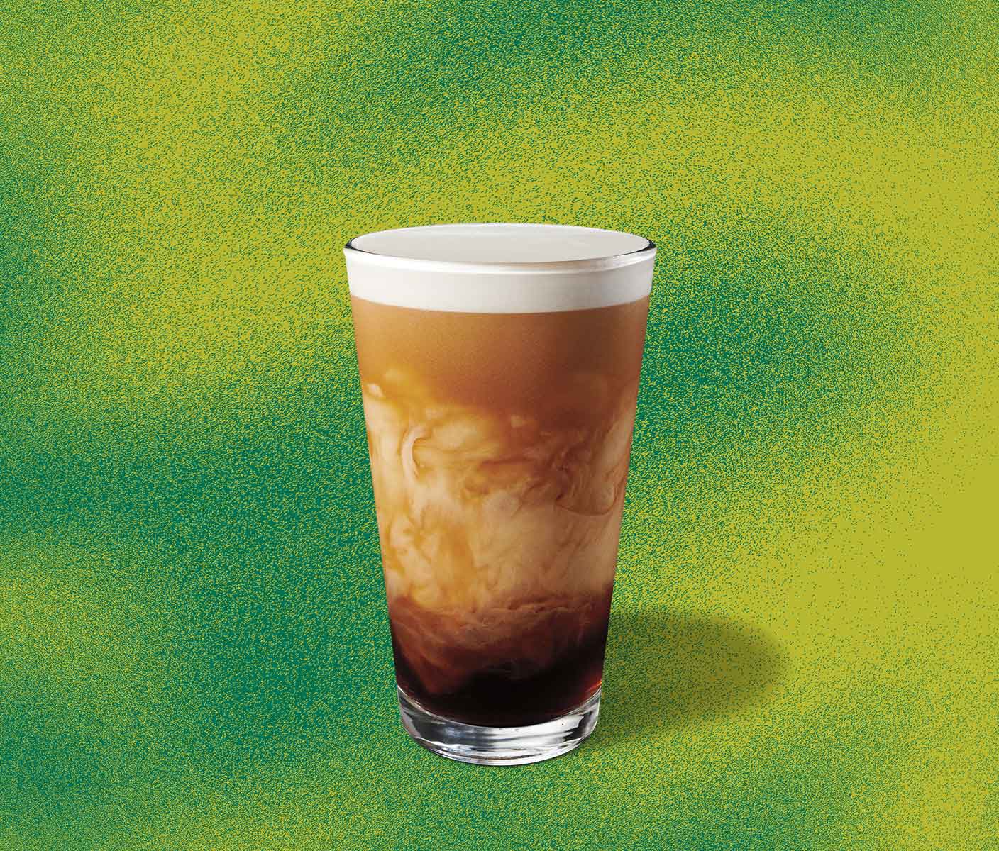 Cold coffee with creamy marbling in a tall glass.