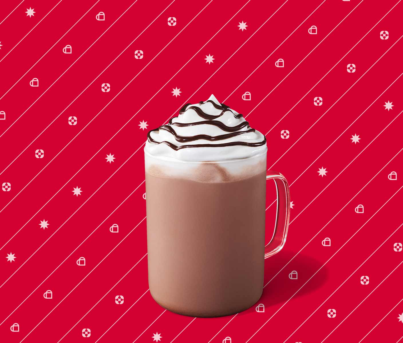 Hot chocolate with whipped cream and chocolate drizzle in a glass mug.