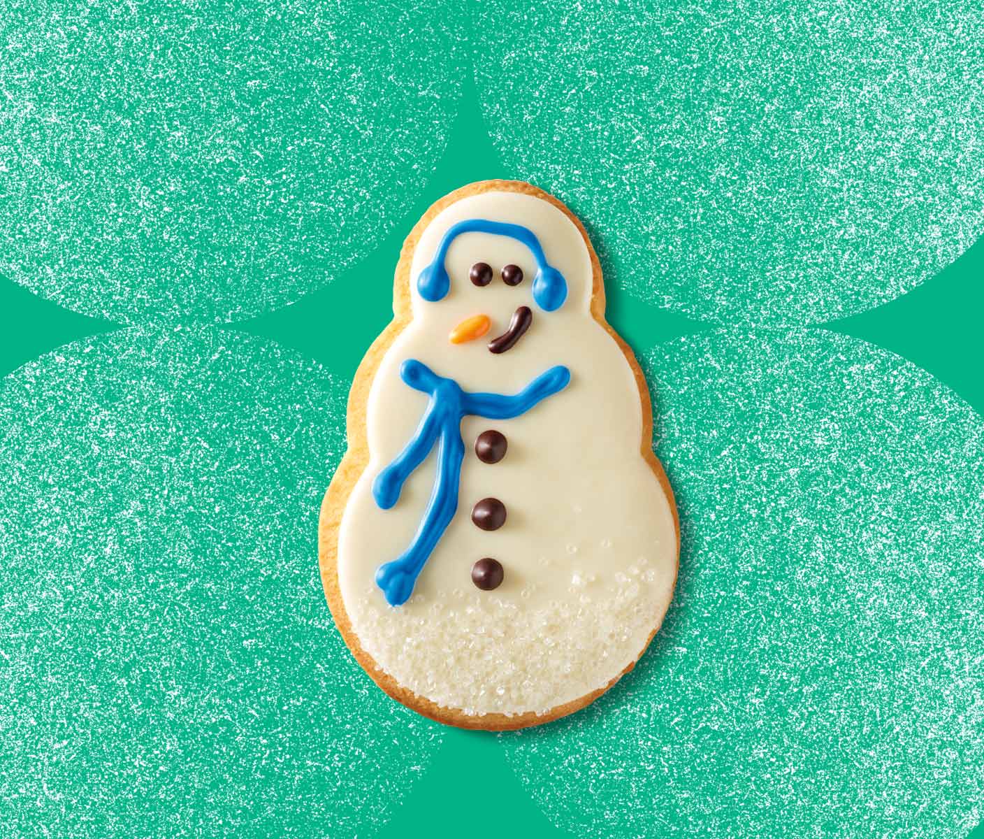 Snowman-shaped cookie covered in white icing and decorated to look like a snowman.