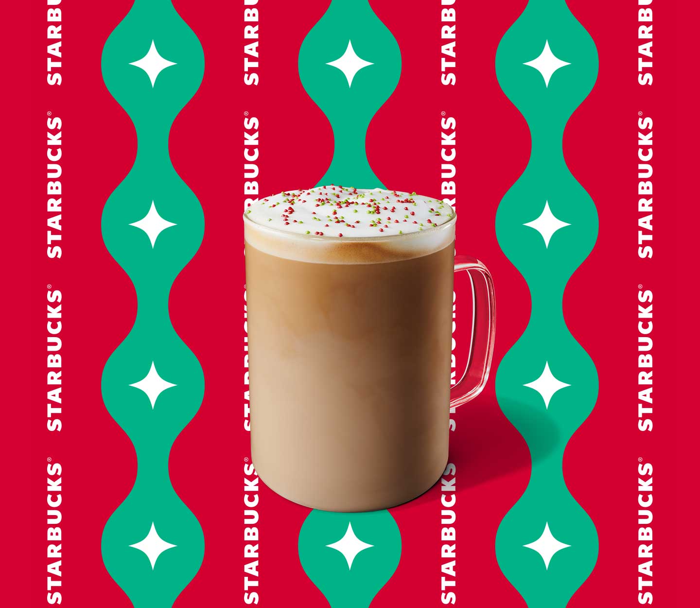 Creamy iced espresso drink with red and green sprinkles in a tall glass.