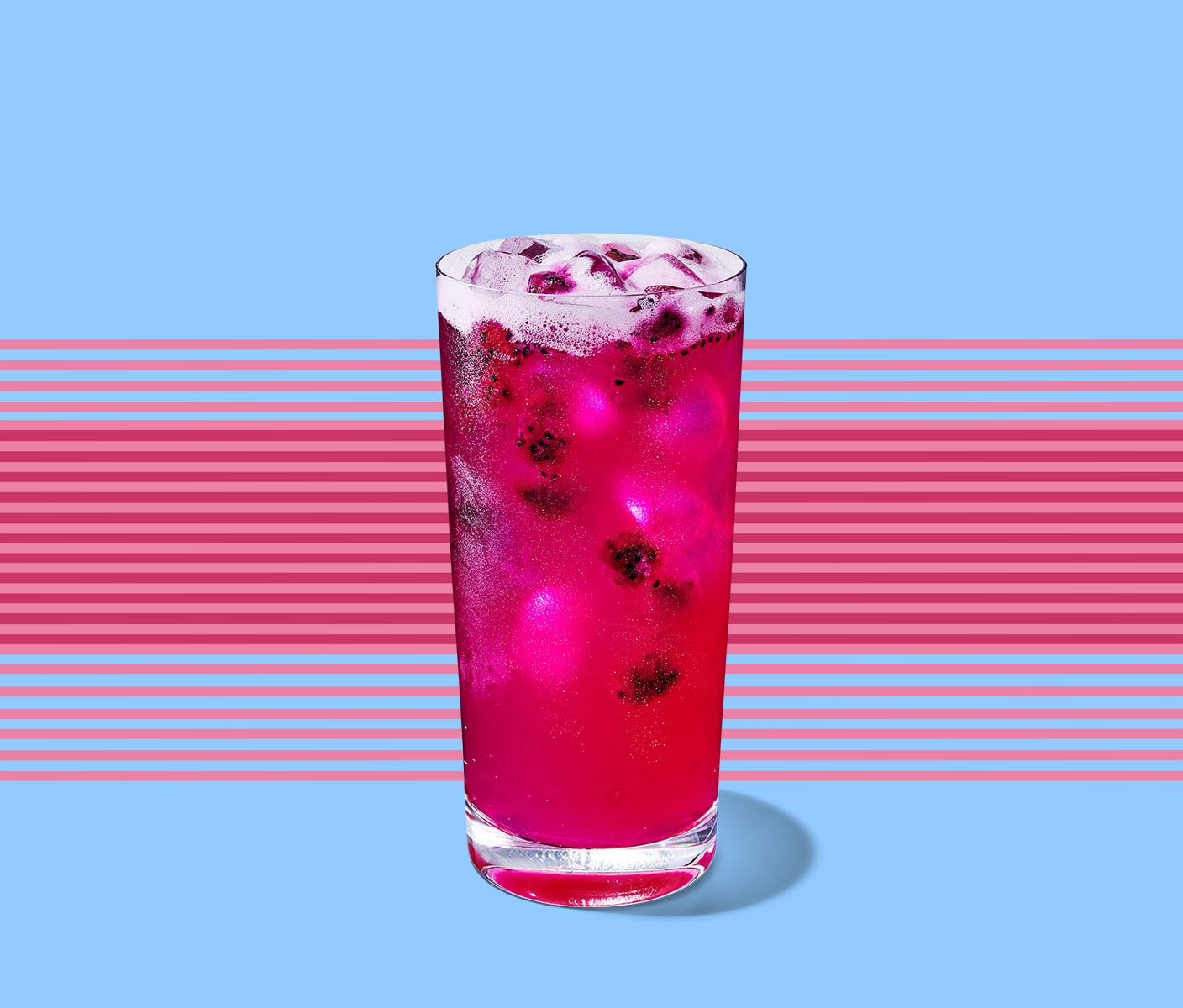 Tropical drink with fruit inclusions and ice cubes in a tall, thin glass. A series of horizontal lines appear behind.