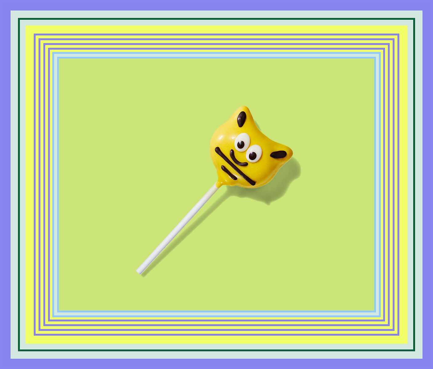 A bee-shaped cake pop covered in yellow frosting with a cartoonish-face.