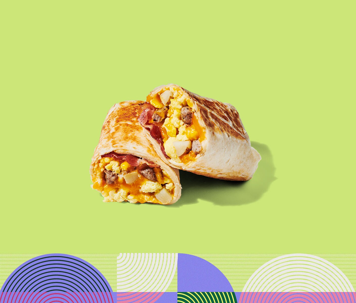 A cooked wrap filled with a combination of breakfast ingredients, cut in half and stacked on itself.
