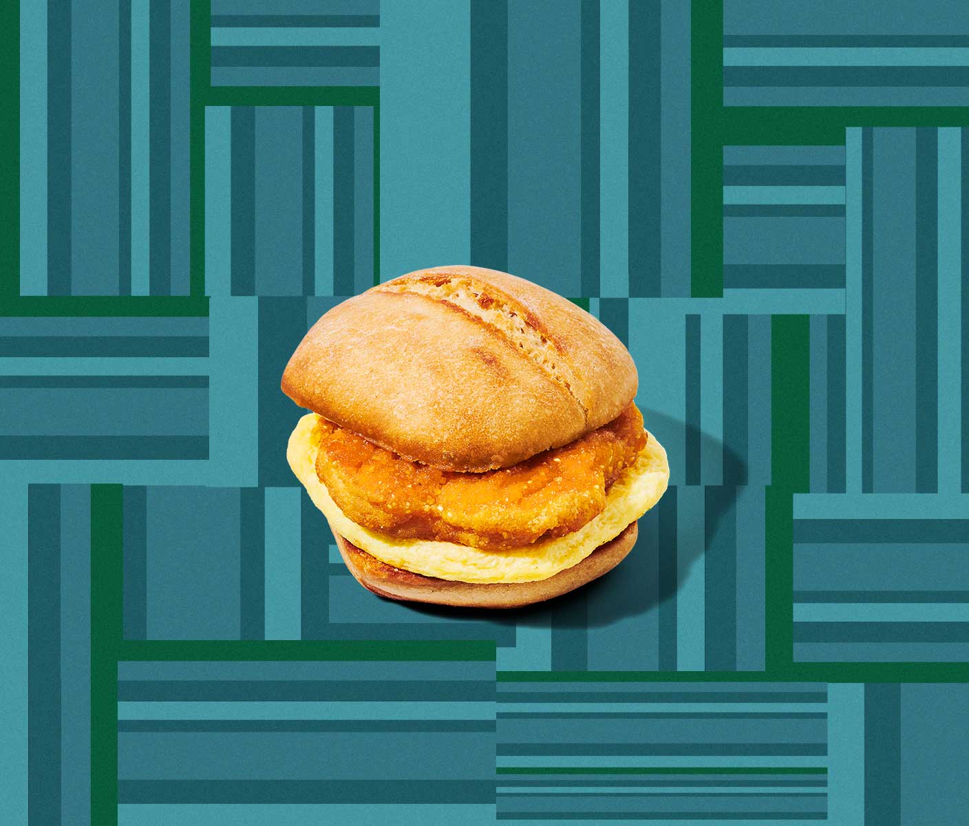 A breakfast sandwich showing breaded chicken on top of an egg patty.