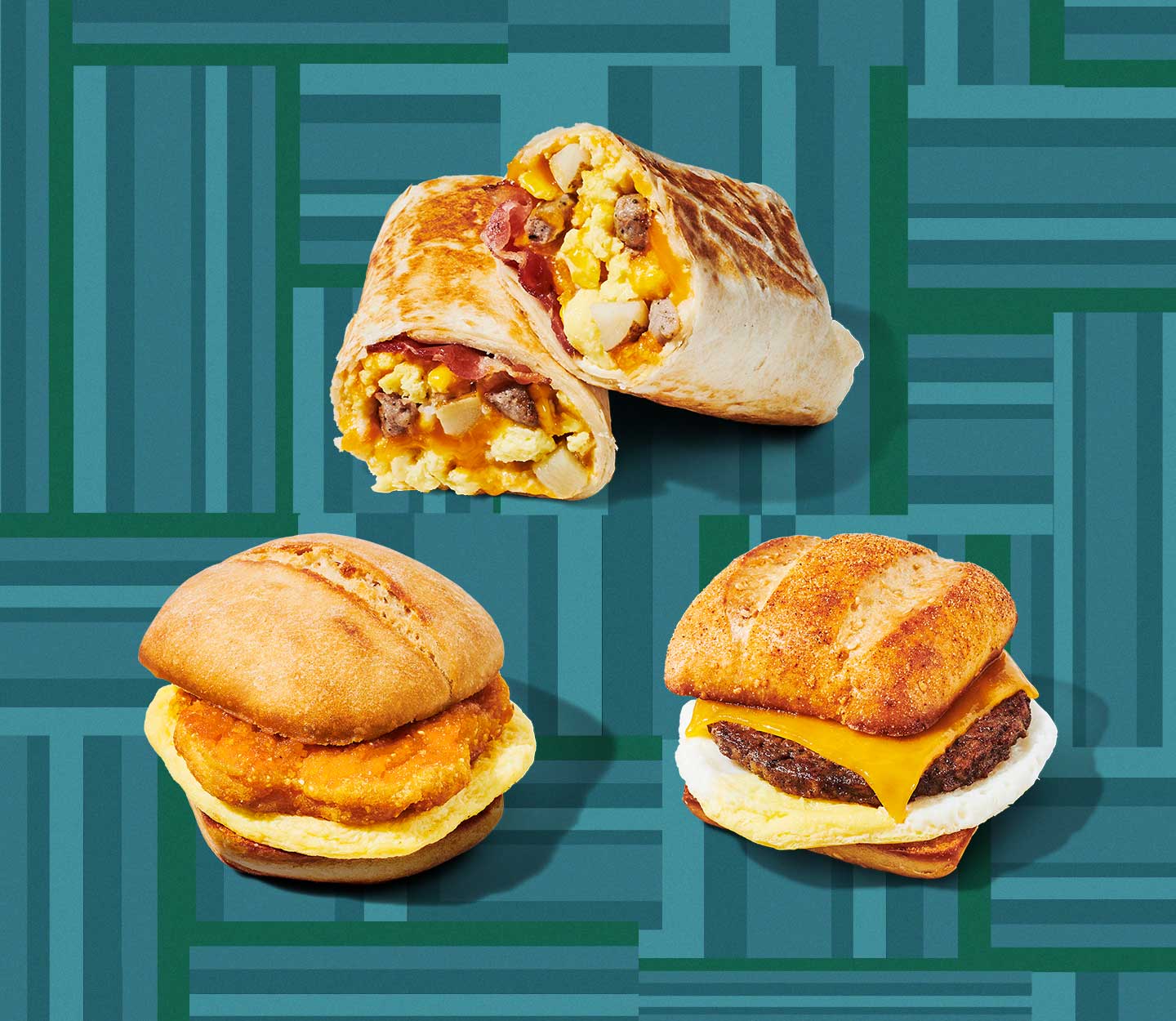 A cut and stacked breakfast wrap, chicken breakfast sandwich and meatless breakfast sandwich arranged in a triangle shape.