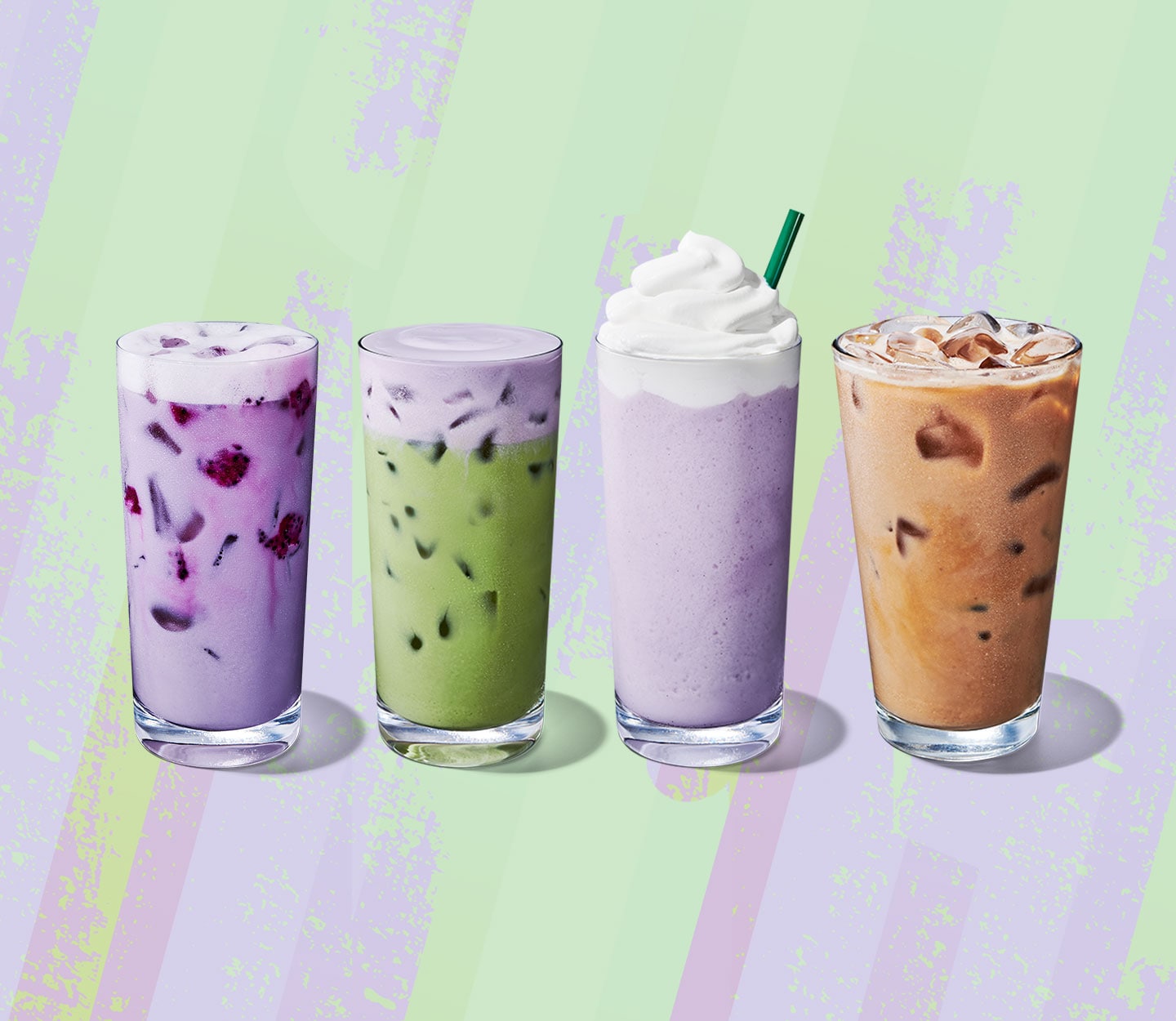Four cold drinks in tall glasses. One is purple with fruit bits, one is green with creamy foam, one is light brown, and one is pale purple with whipped cream and a straw.