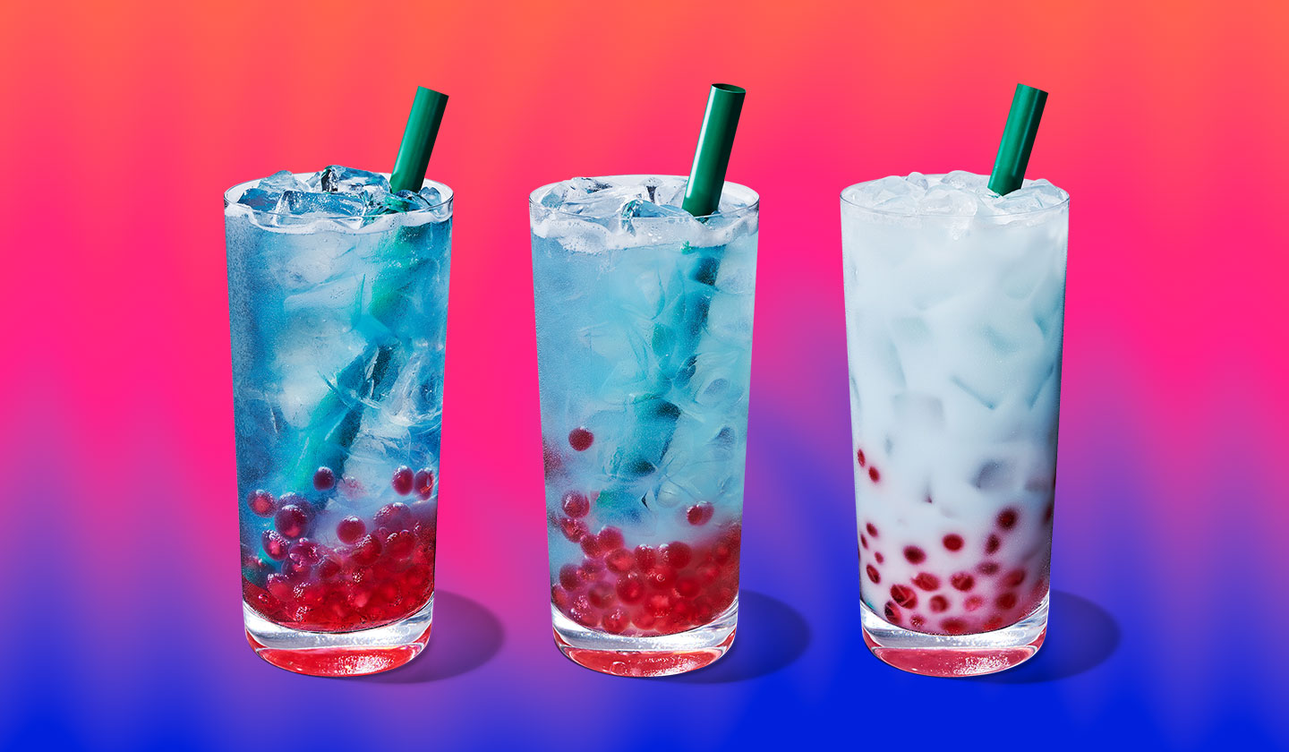 Three blue cold drinks with red pearls at the bottom. The shade of blue progresses from dark to creamy, one drink to the next.