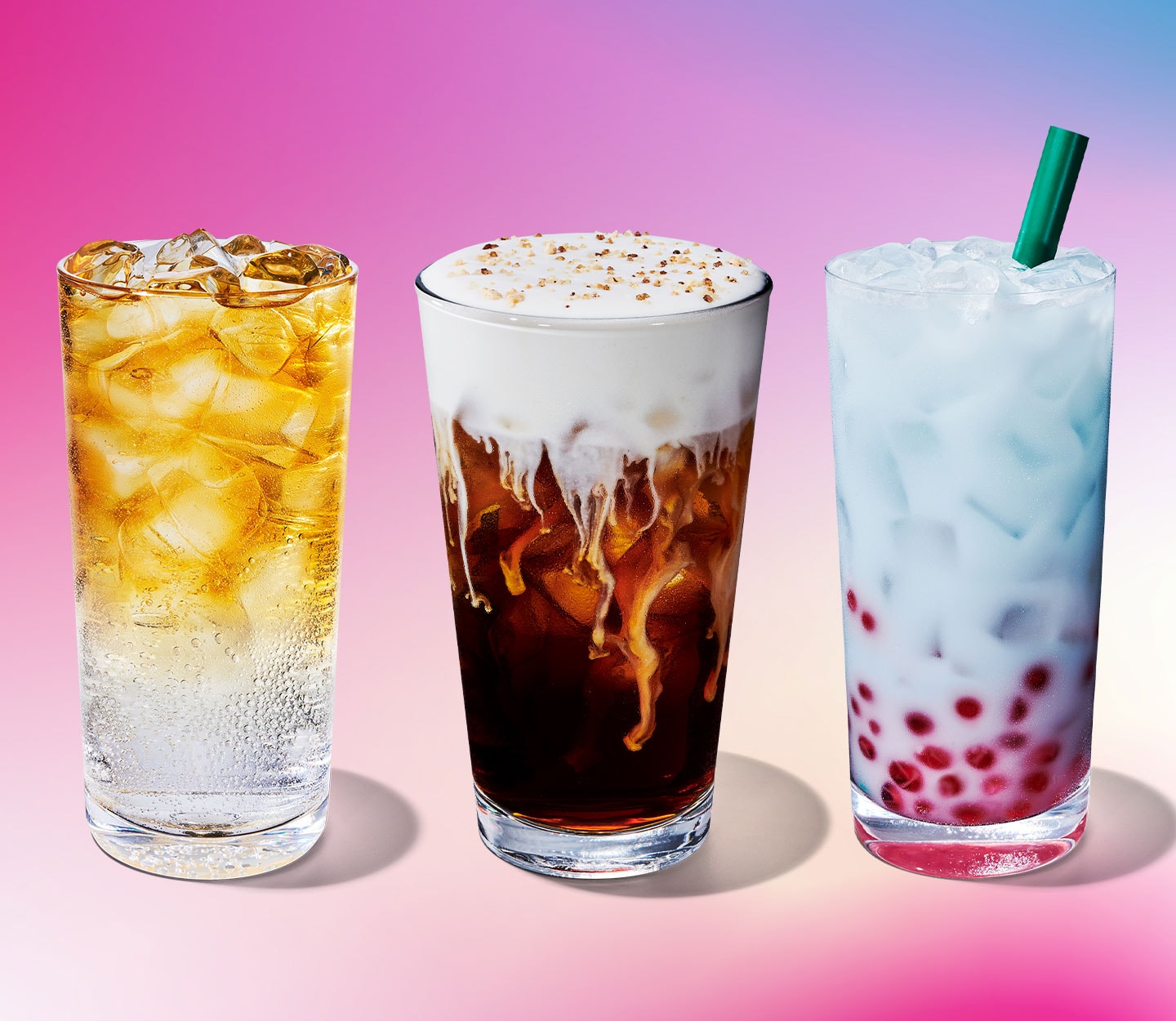 A carbonated iced drink with tea on top, an iced coffee with a creamy foam topping, and a light blue creamy iced drink with pink pearls.