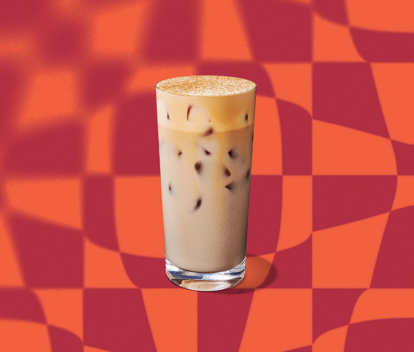 An iced, creamy tea drink with a layer of foaminess in a tall glass