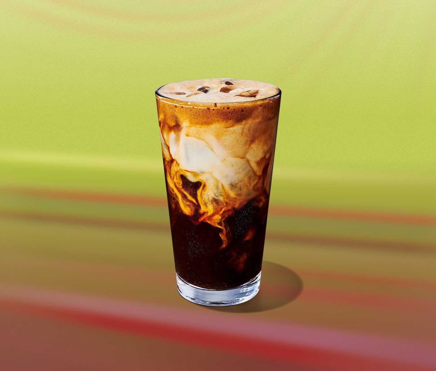 An iced coffee drink in tall glasses with creamy marbling throughout.