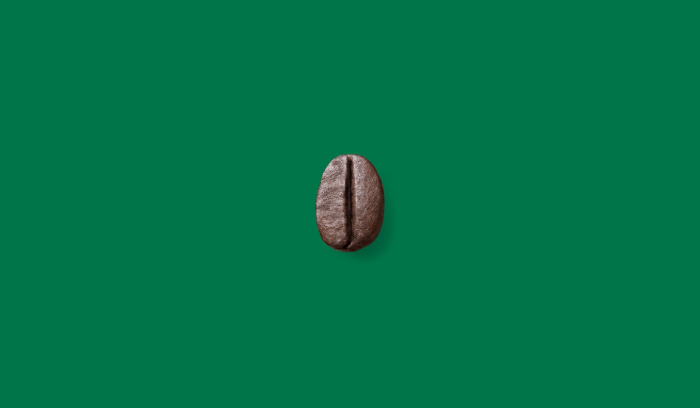 A single coffee bean centered on a green background.