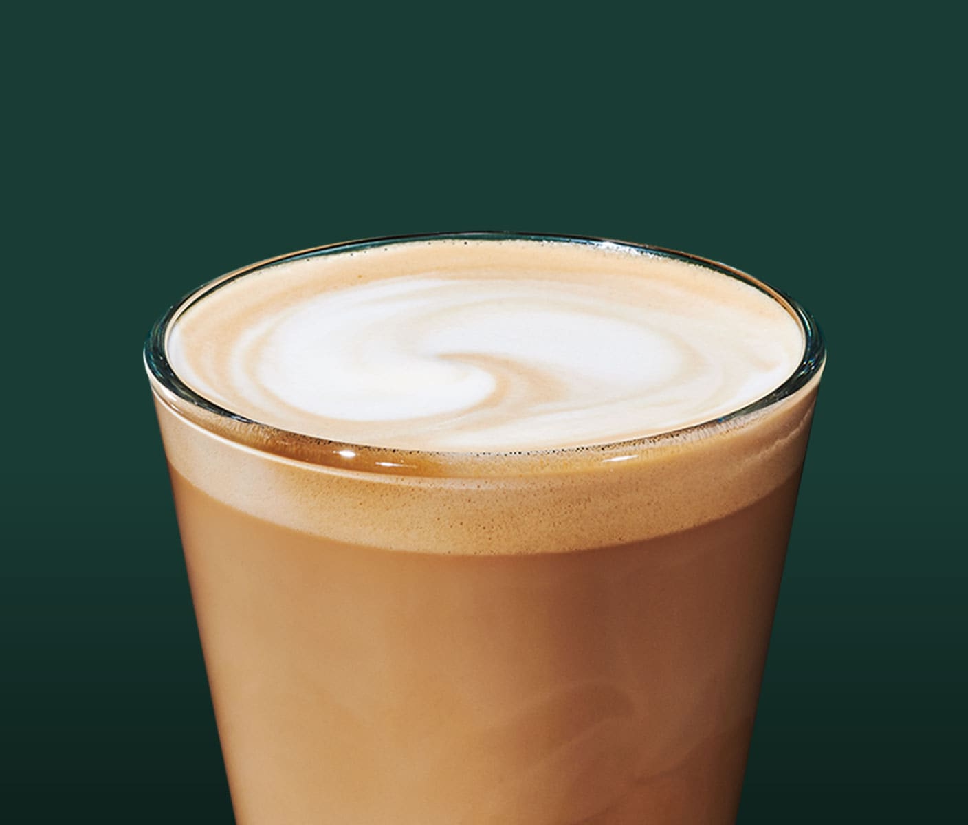 A short-sized creamy coffee drink with a frothy top in clear glass.