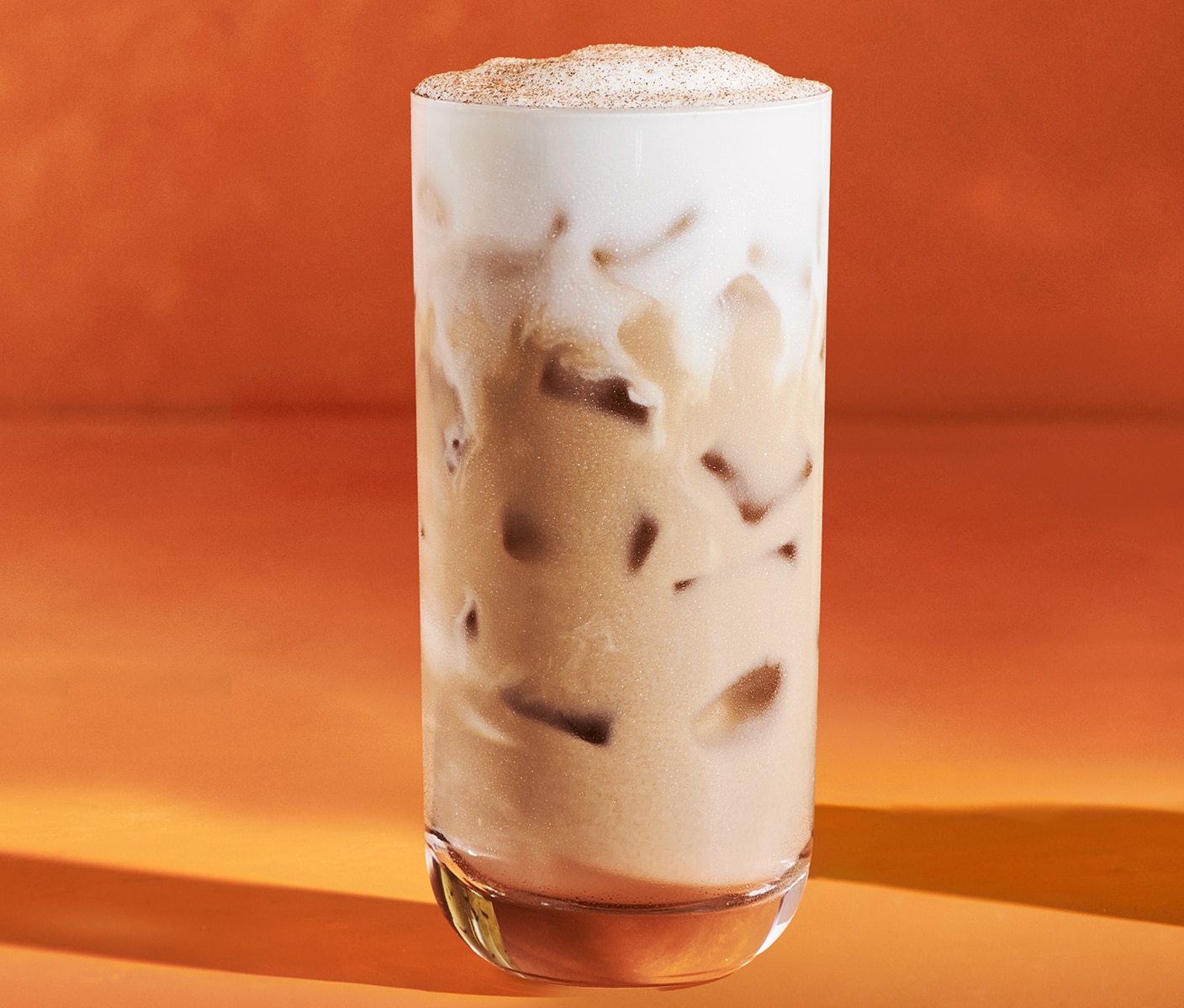 An iced chai with brown sugar cream cold foam and spices.