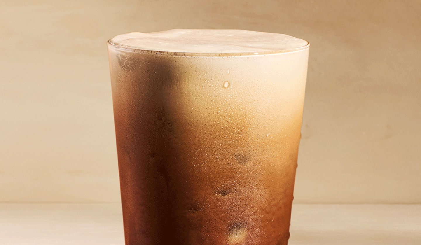 A freshly-poured Aerocano. Light foam at the top deepens gradually down the glass into dark espresso.