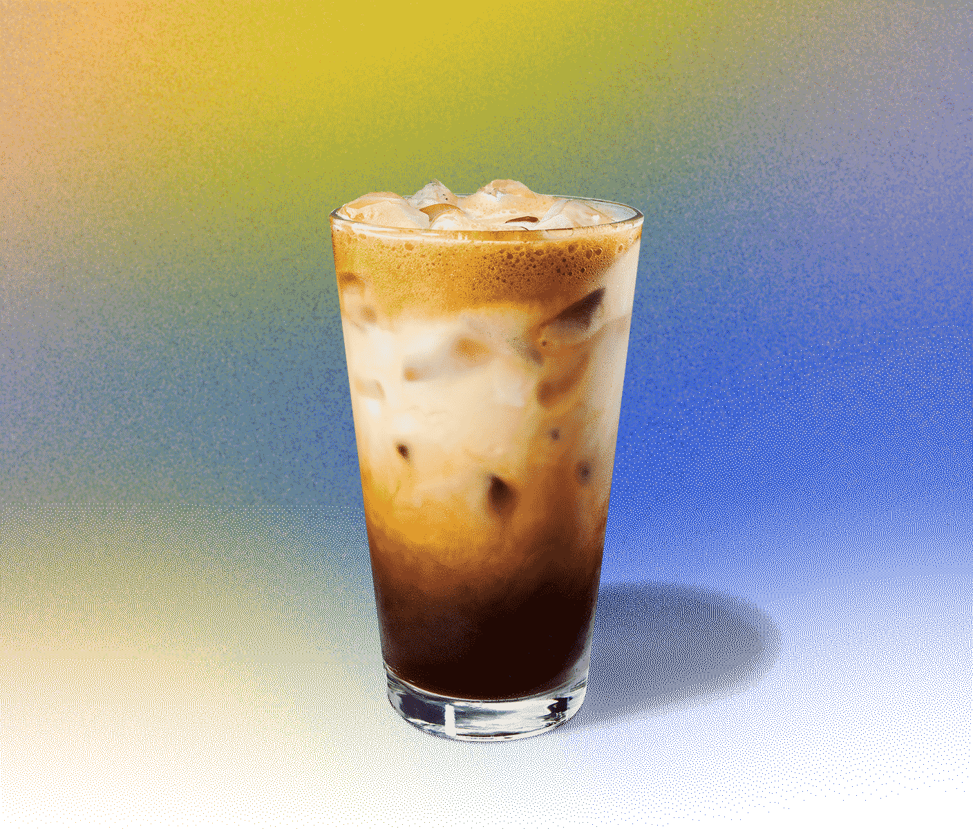 Iced coffee drink with creamy swirls in a tall glass