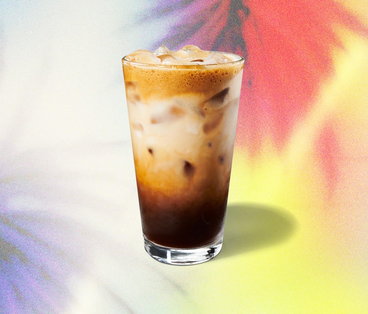 Layered, iced espresso beverage in a glass.