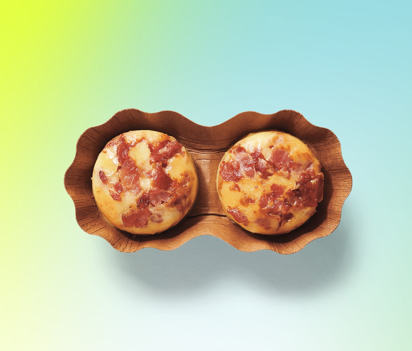 Two round egg bites in a fluted container.