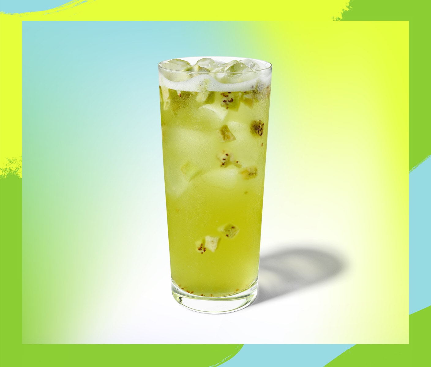 Iced beverage with fruit pieces in a tall glass.