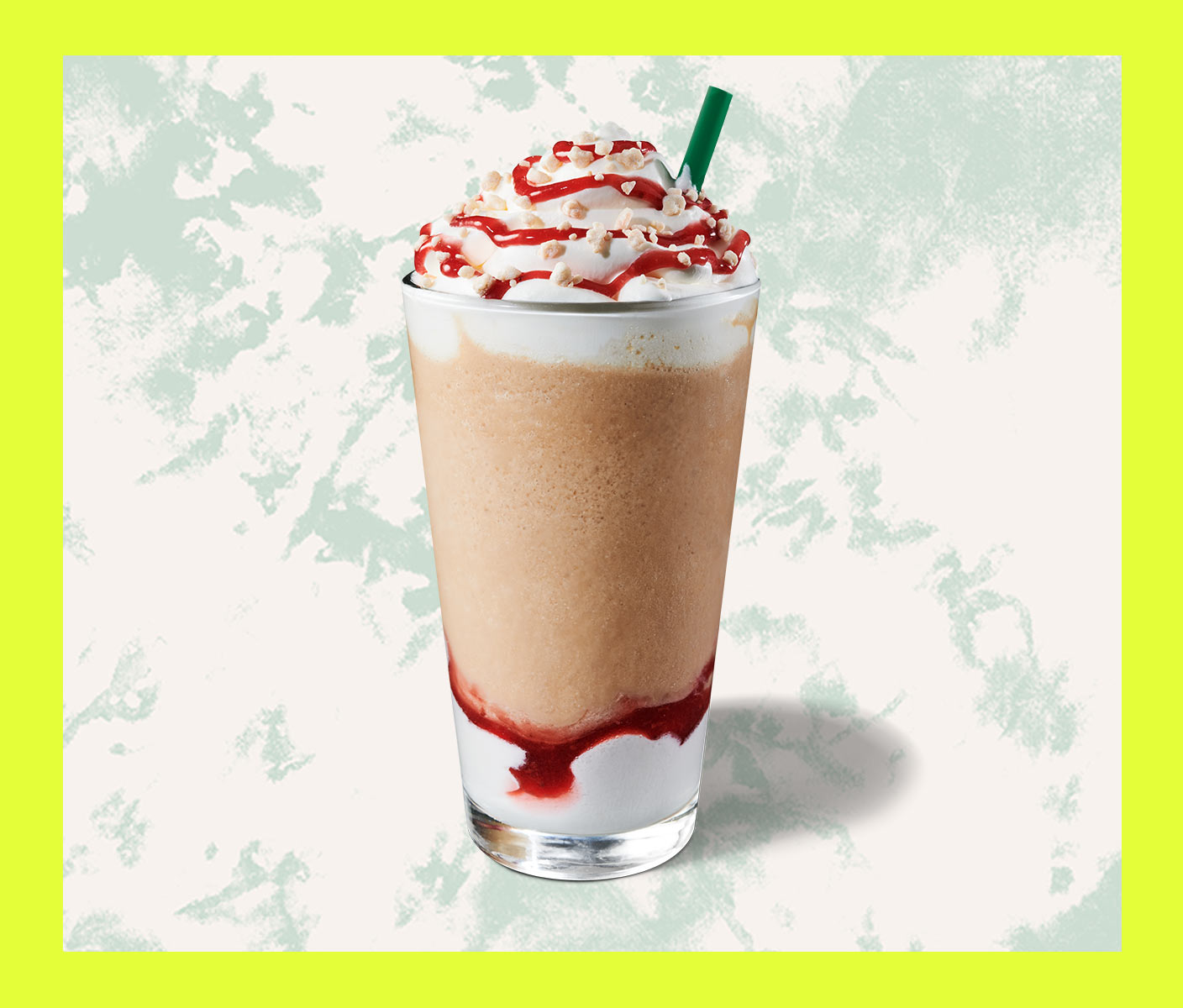 Blended coffee drink with whip cream and strawberry topping in a tall glass.