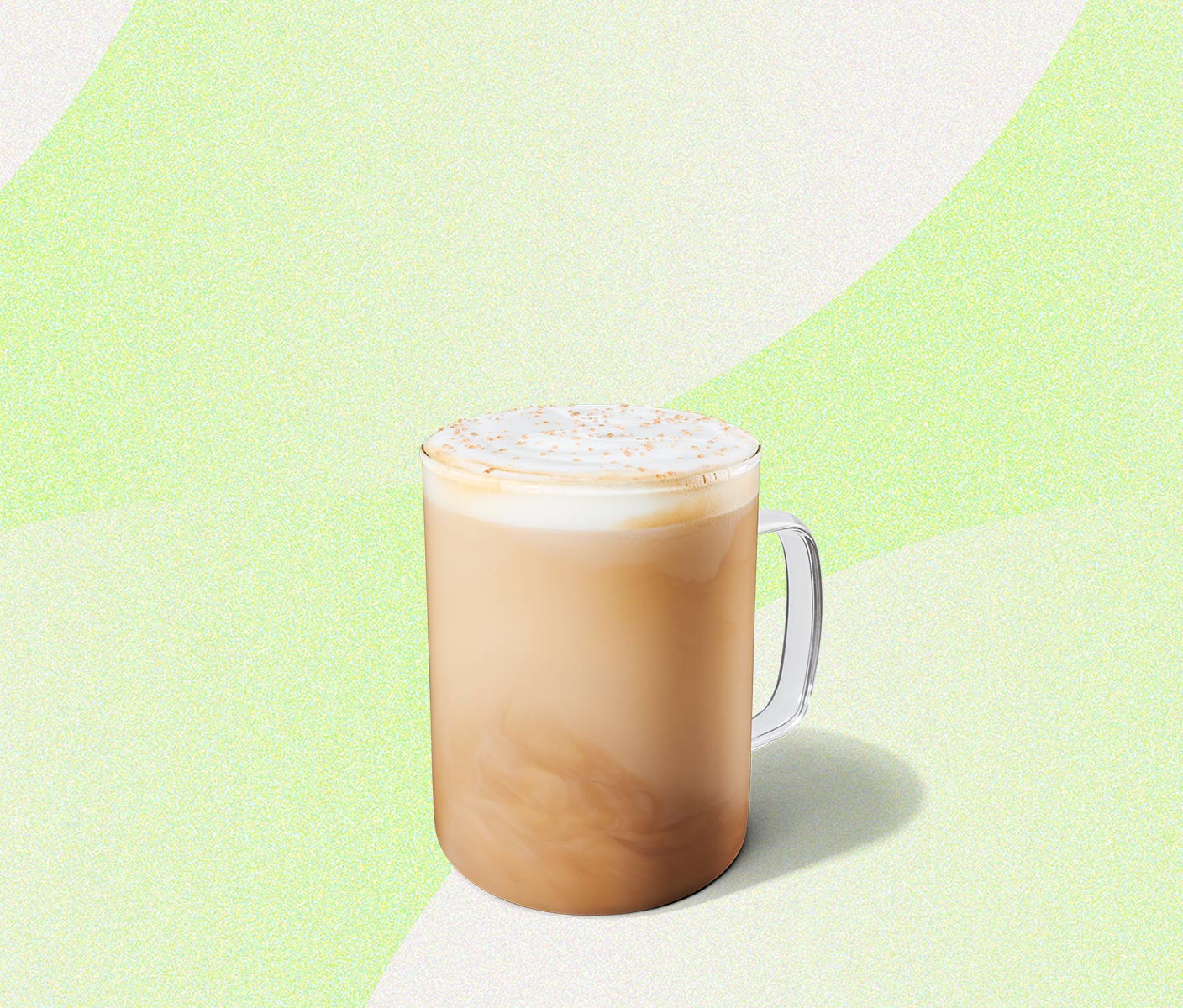 Creamy latte in a glass mug.