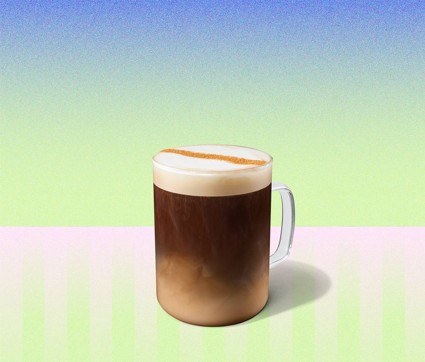 Hot coffee drink with a strike of cinnamon in a glass mug