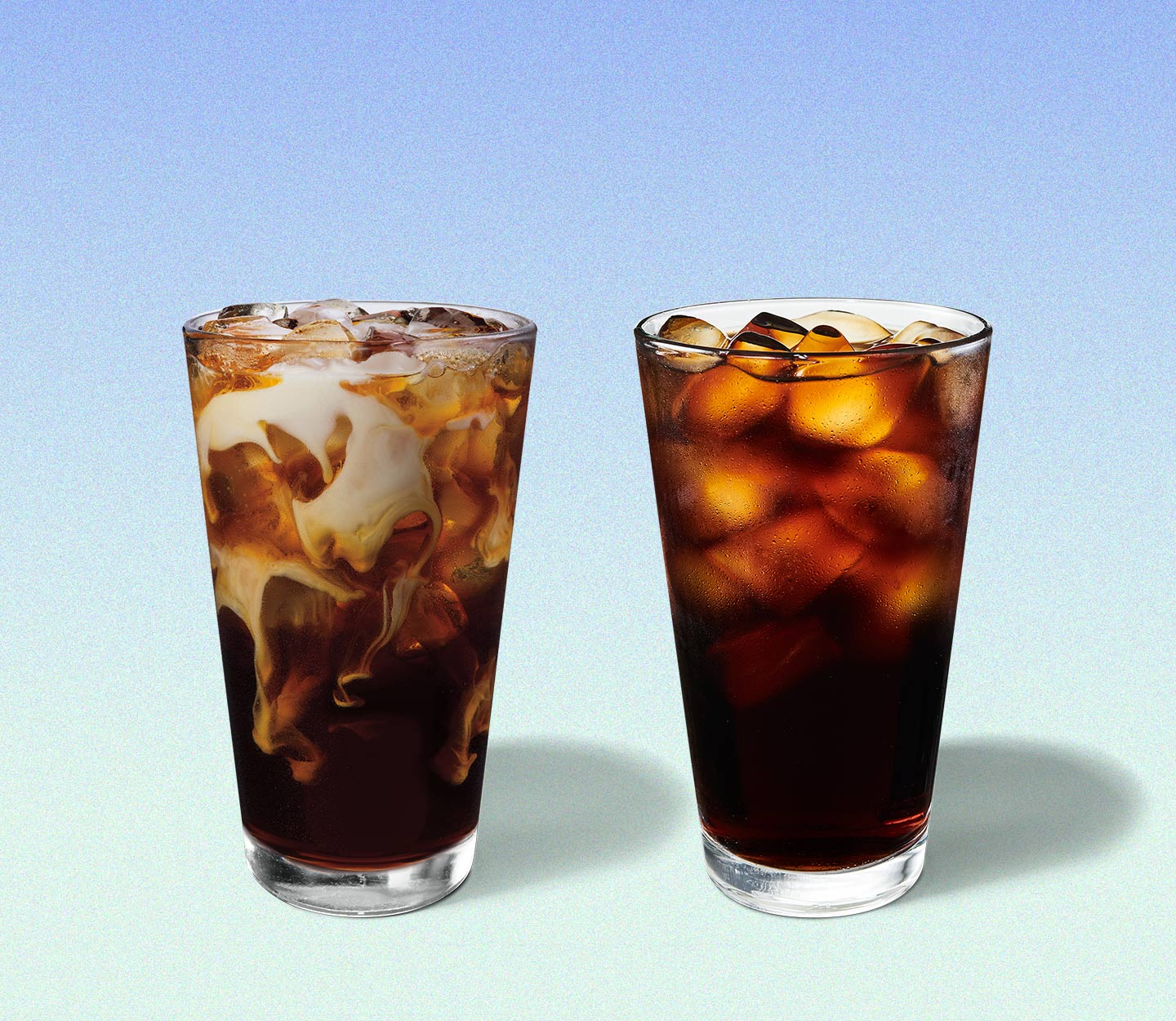 Marbled, iced coffee drink next to a second iced coffee drink. Both are served in tall glasses.
