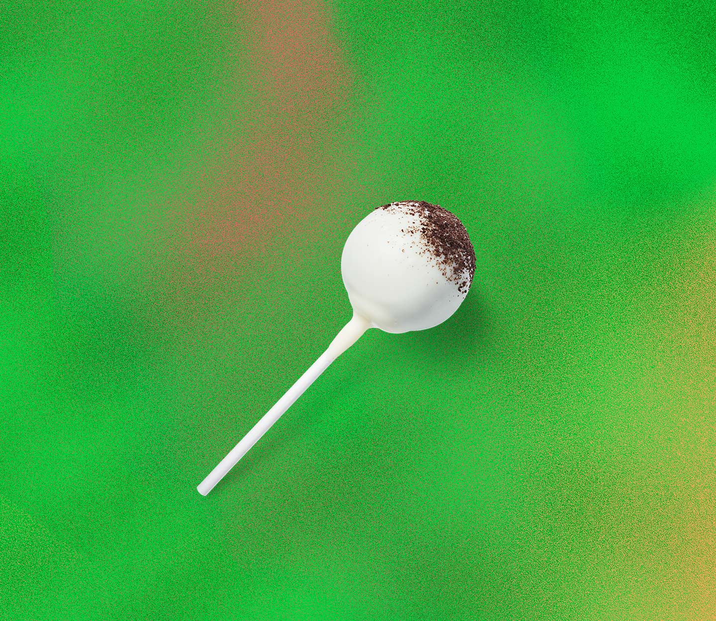 Cake pop with white icing topped with cookie crumbs.