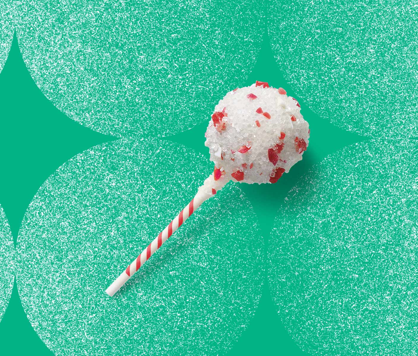Cake pop covered in white icing and bits of candy cane.