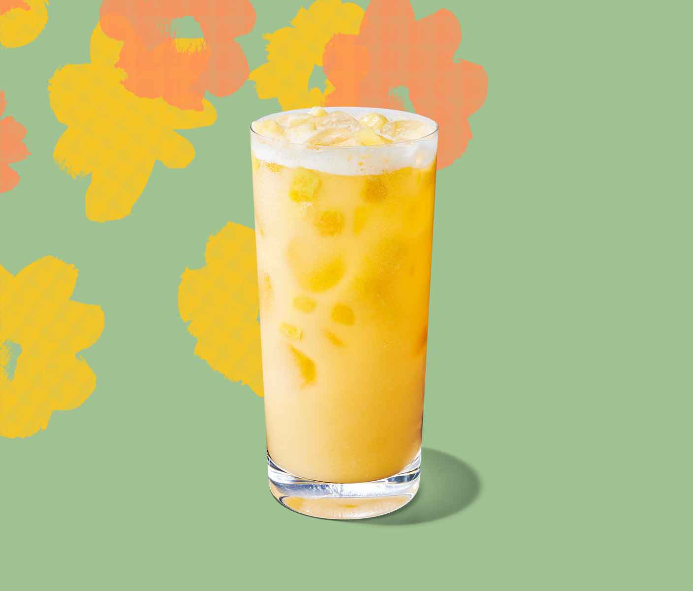 Creamy yellow iced drink with pineapple inclusions in a tall glass.